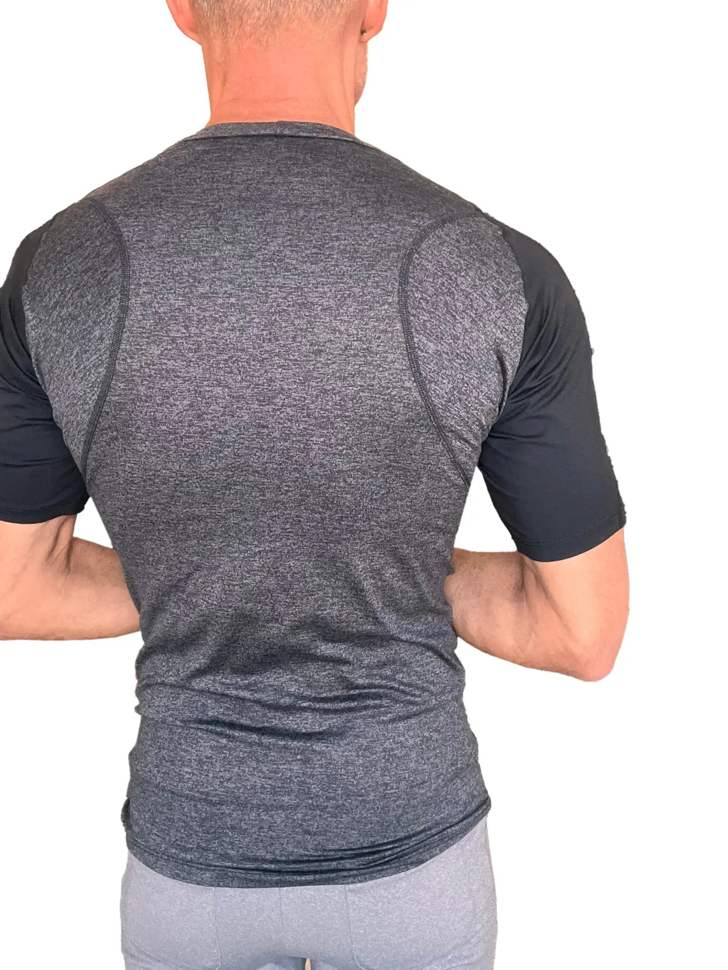A men’s designer raglan crew-neck tee with heathered charcoal body, black sleeves, and subtle seam detailing for performance fit