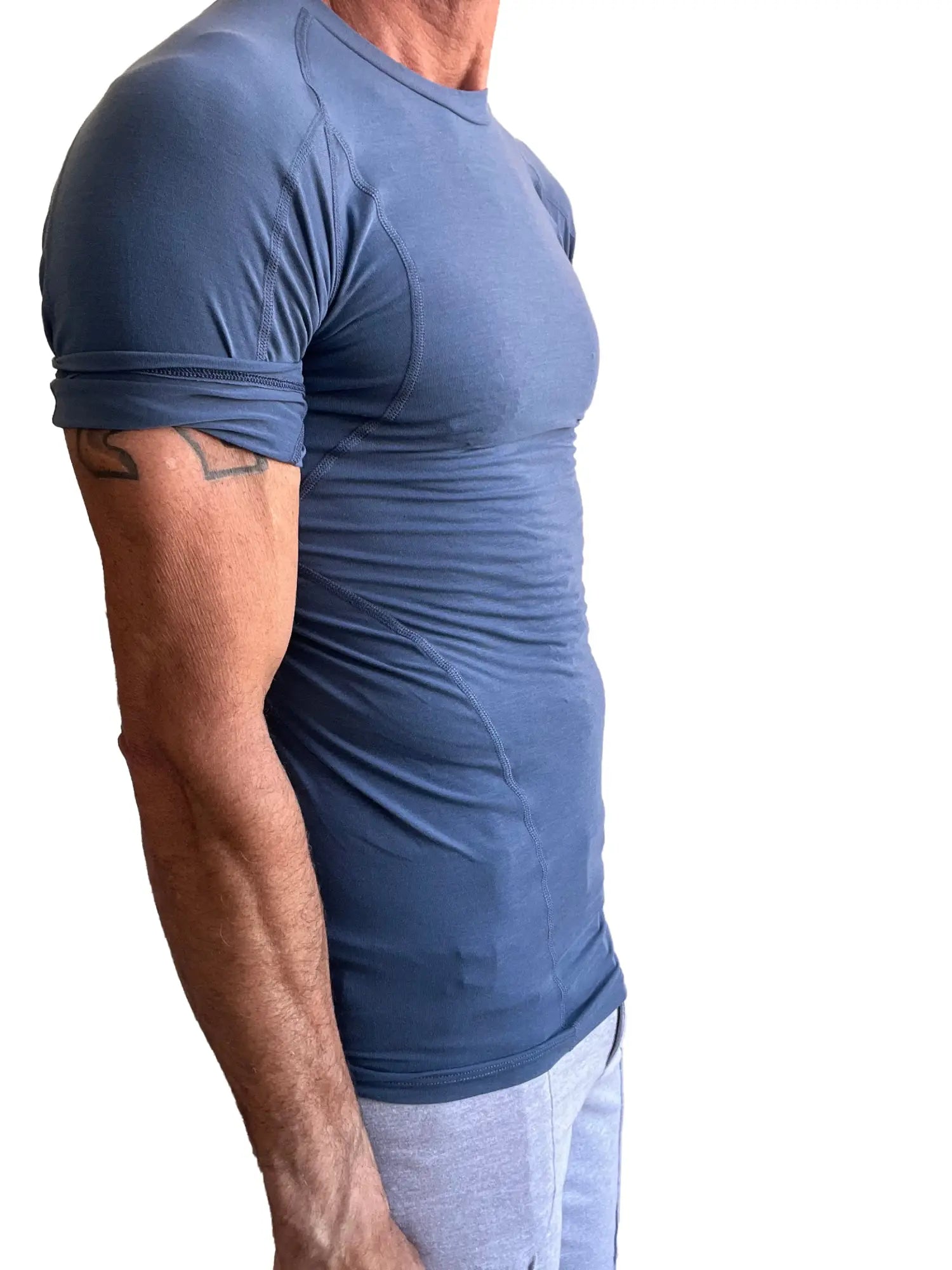 Designer raglan crew-neck tee denim blue fitted short-sleeved athletic shirt with rolled-up sleeves and subtle seams