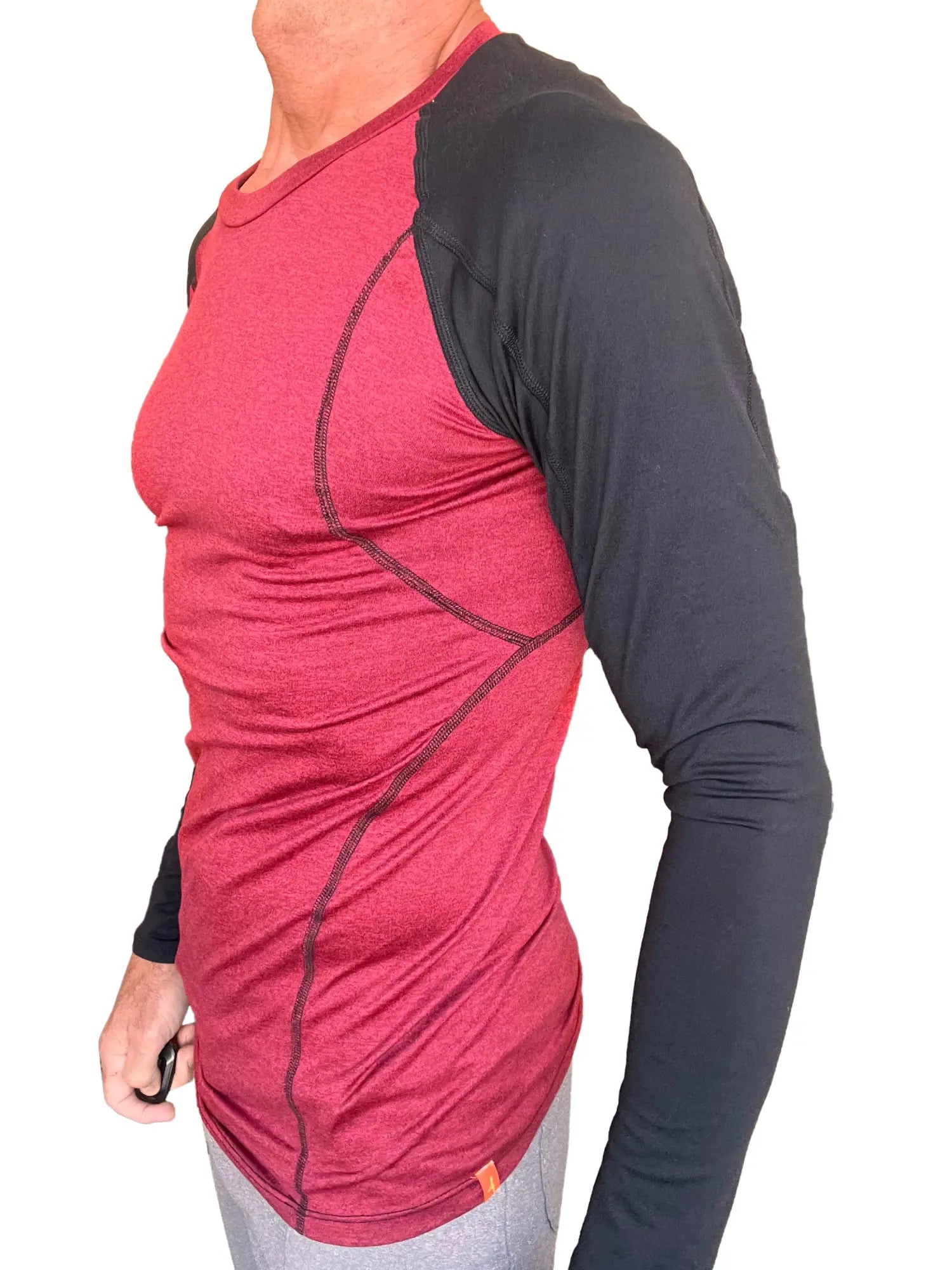 A men’s long-sleeved designer raglan crew-neck athletic shirt with a red heathered body and black sleeves