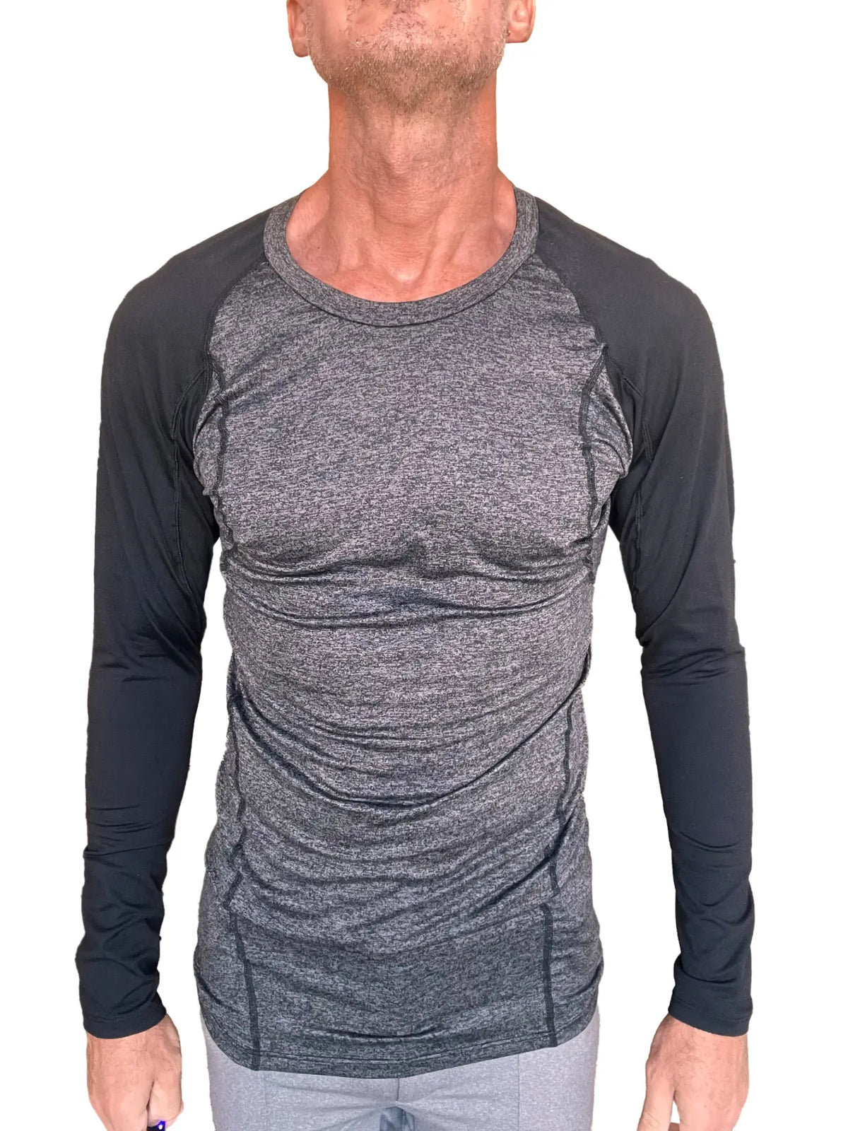 A men’s fitted long-sleeved athletic shirt in charcoal heather gray with black raglan sleeves for active wear