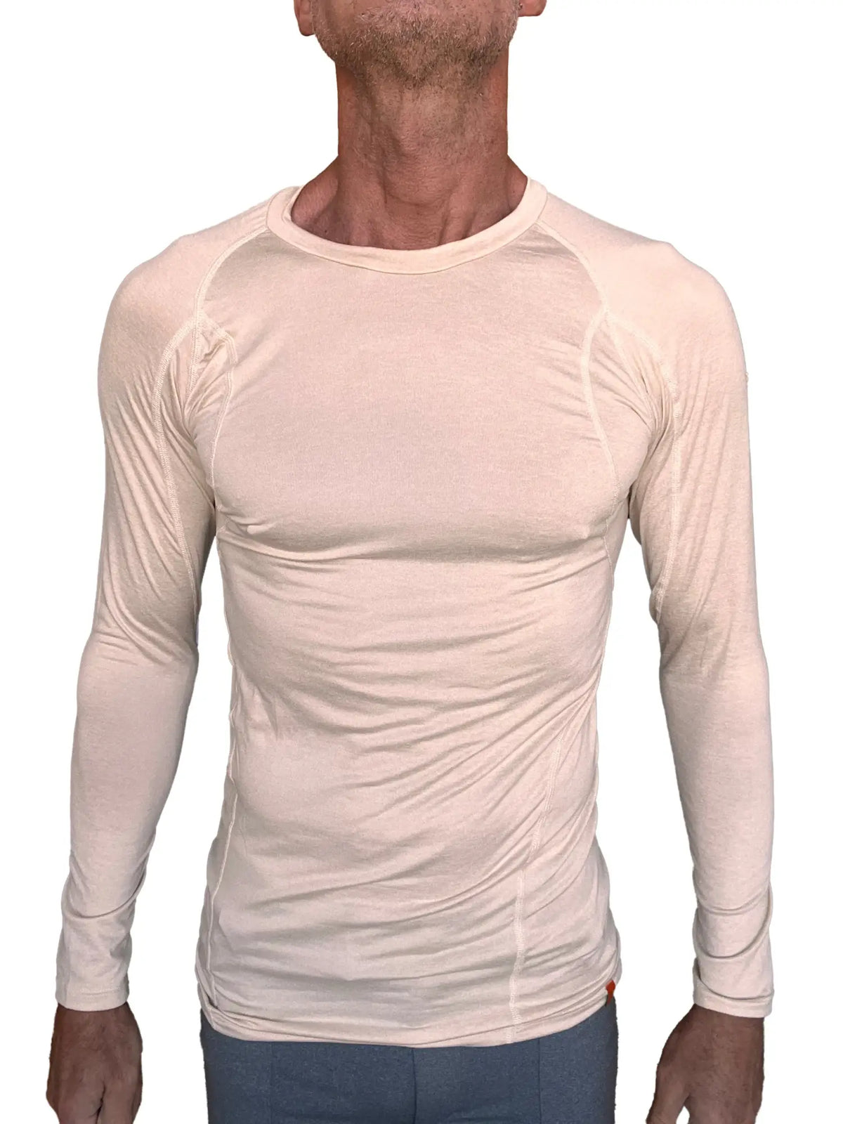 Beige long-sleeved designer raglan crew-neck performance tee with subtle seam detailing in sand beige color