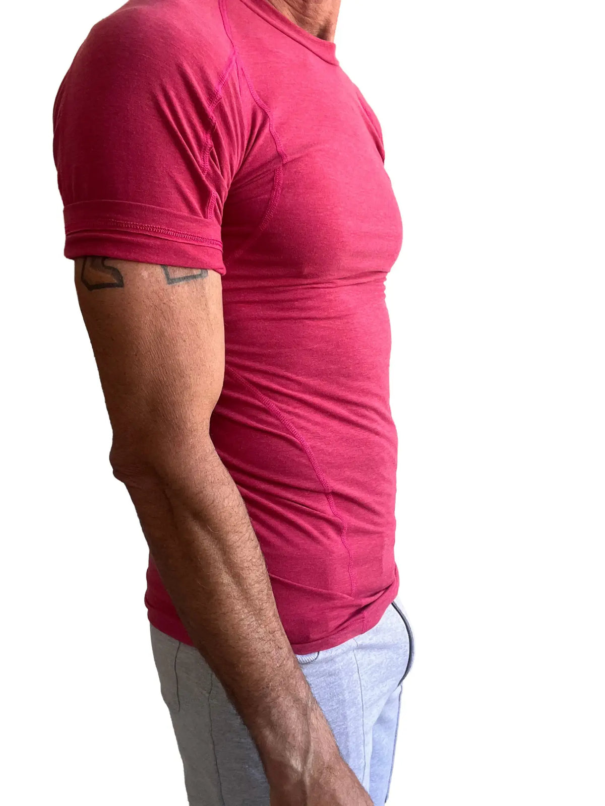 A fitted short-sleeved pink athletic tee with crew neck and subtle seam detailing called Designer Raglan Crew-Neck Tee raspberry