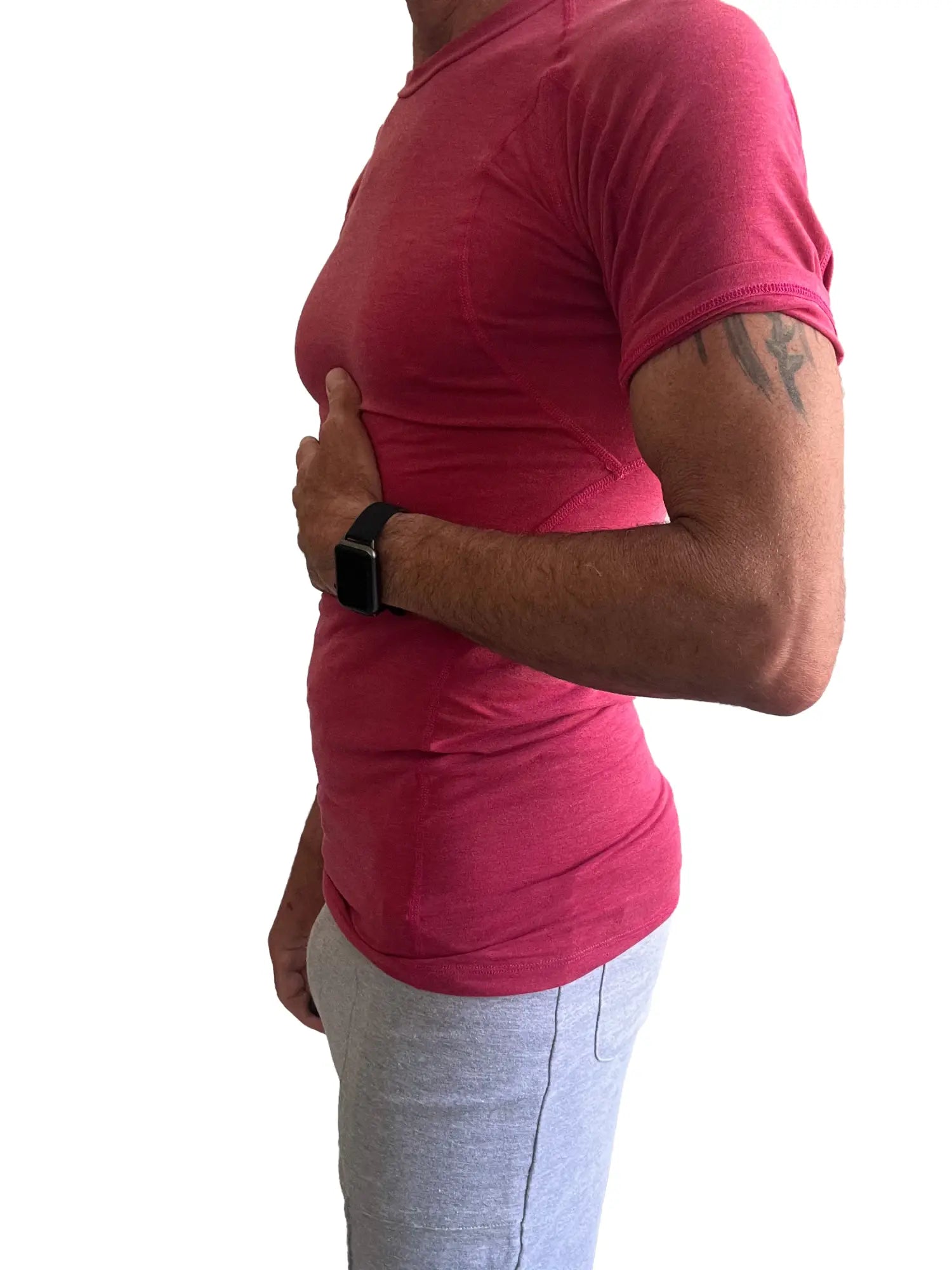A person wearing a vibrant raspberry designer raglan crew-neck tee with subtle ribbed texture and short sleeves