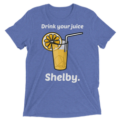 Blue heathered t-shirt featuring a cartoon orange juice glass with lemon slice and straw and text drink your juice shelby