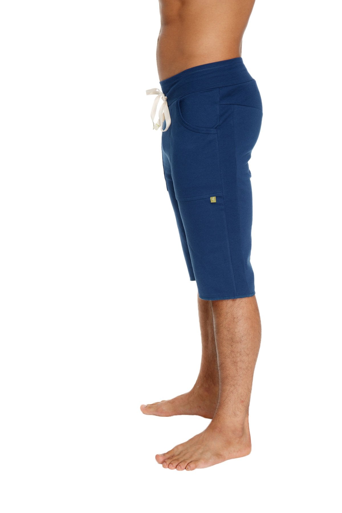 Royal blue eco-track shorts made of cotton with white drawstring and green logo on side pocket