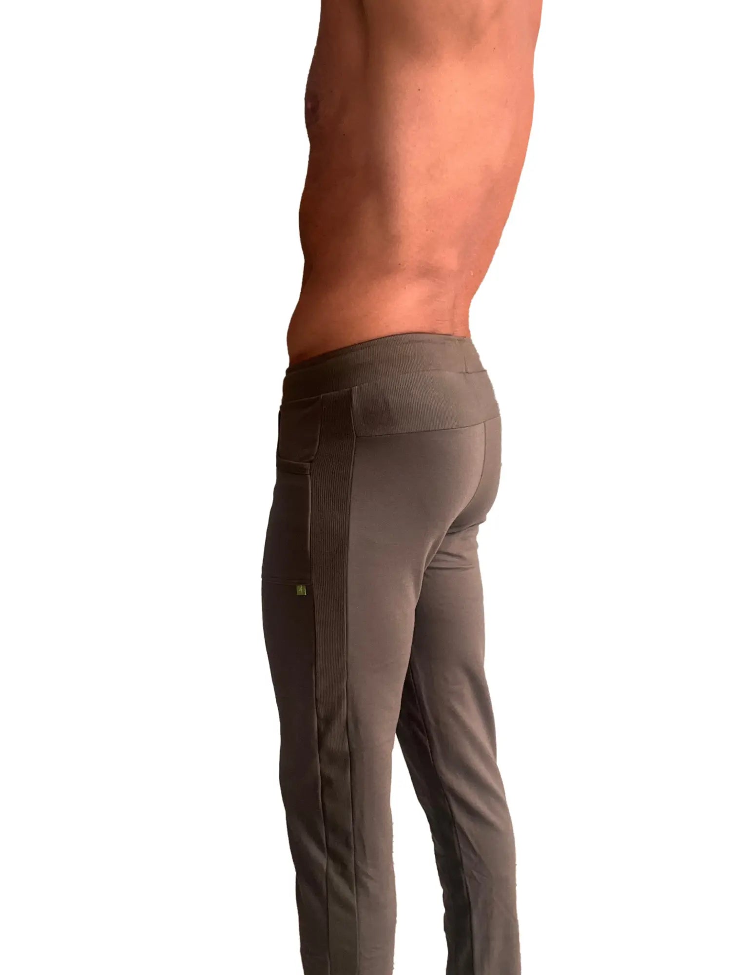 A pair of dark gray eco-track yoga sweat pants with ribbed side panels and subtle thigh branding for athletic use