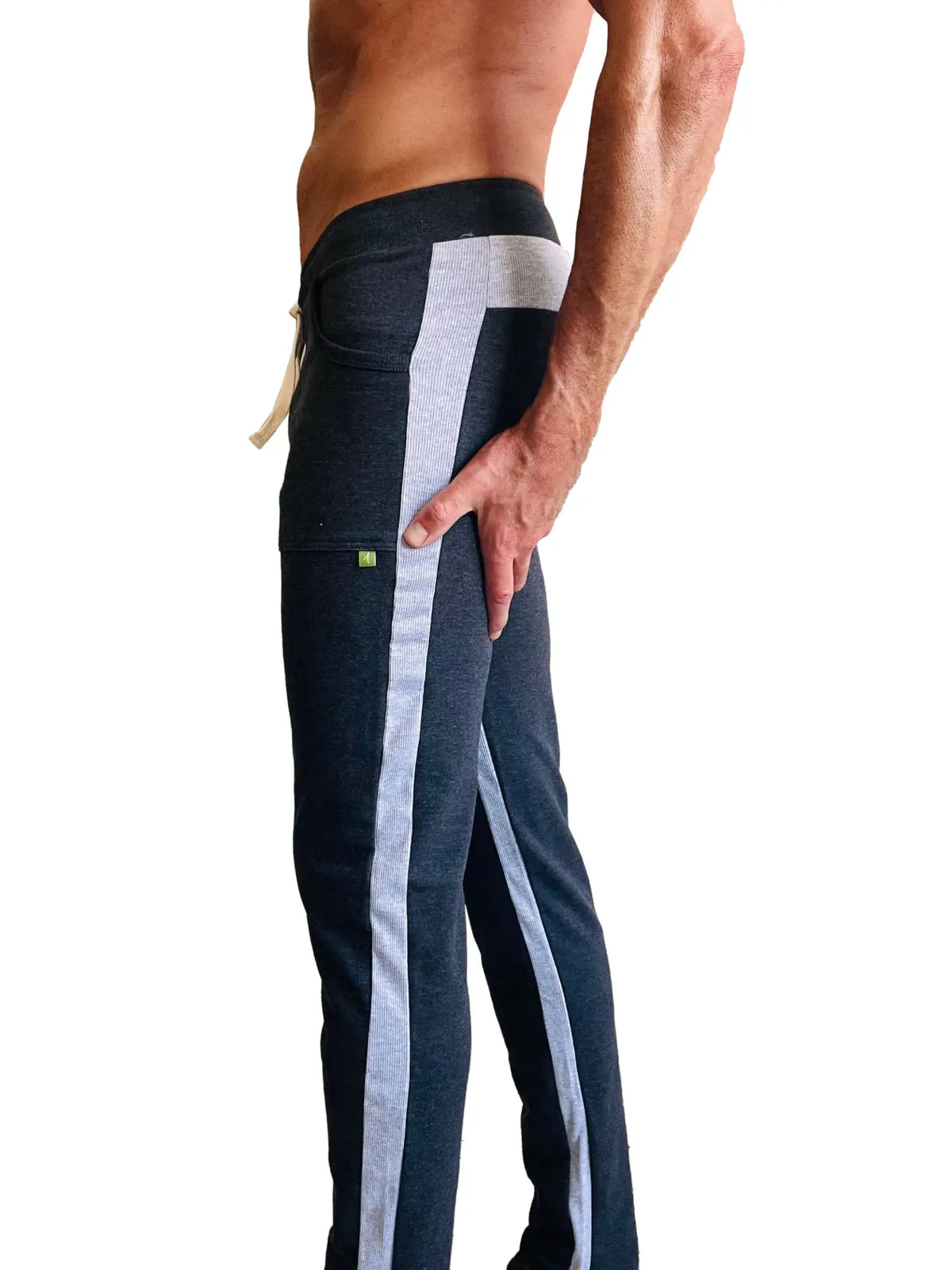 Dark gray eco-track and yoga sweat pants with light gray stripes, side pocket, matching waistband, and green logo on thigh