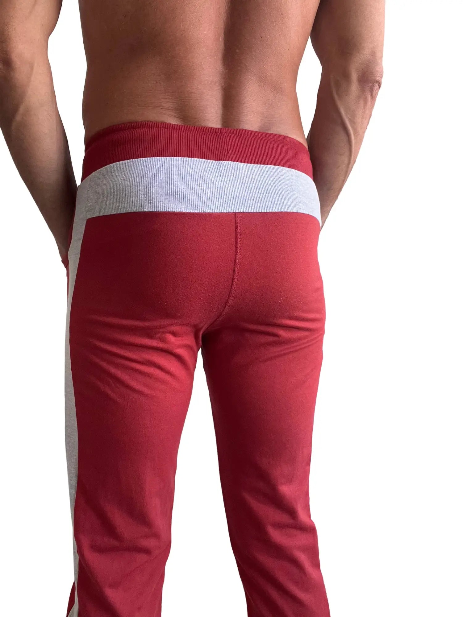 Eco-track and yoga sweat pant in cinnabar red with grey striped waistband and side stripes for athletic use