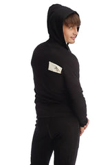 Black edge form-fit crossover yoga track performance hoodie with a white logo patch on the left sleeve