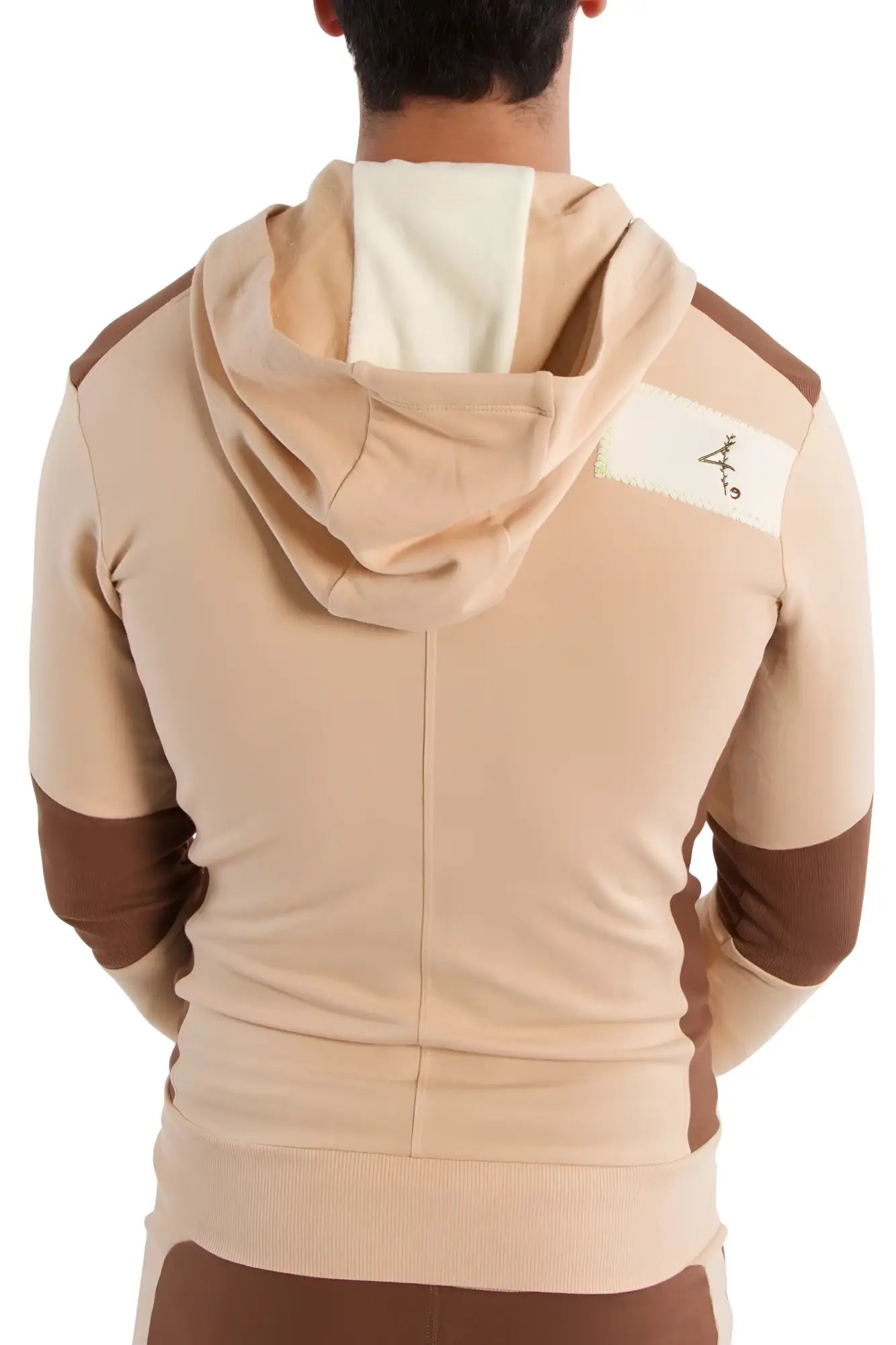 Edge form-fit crossover yoga track performance hoodie in sand and chocolate with a white shoulder patch and black logo