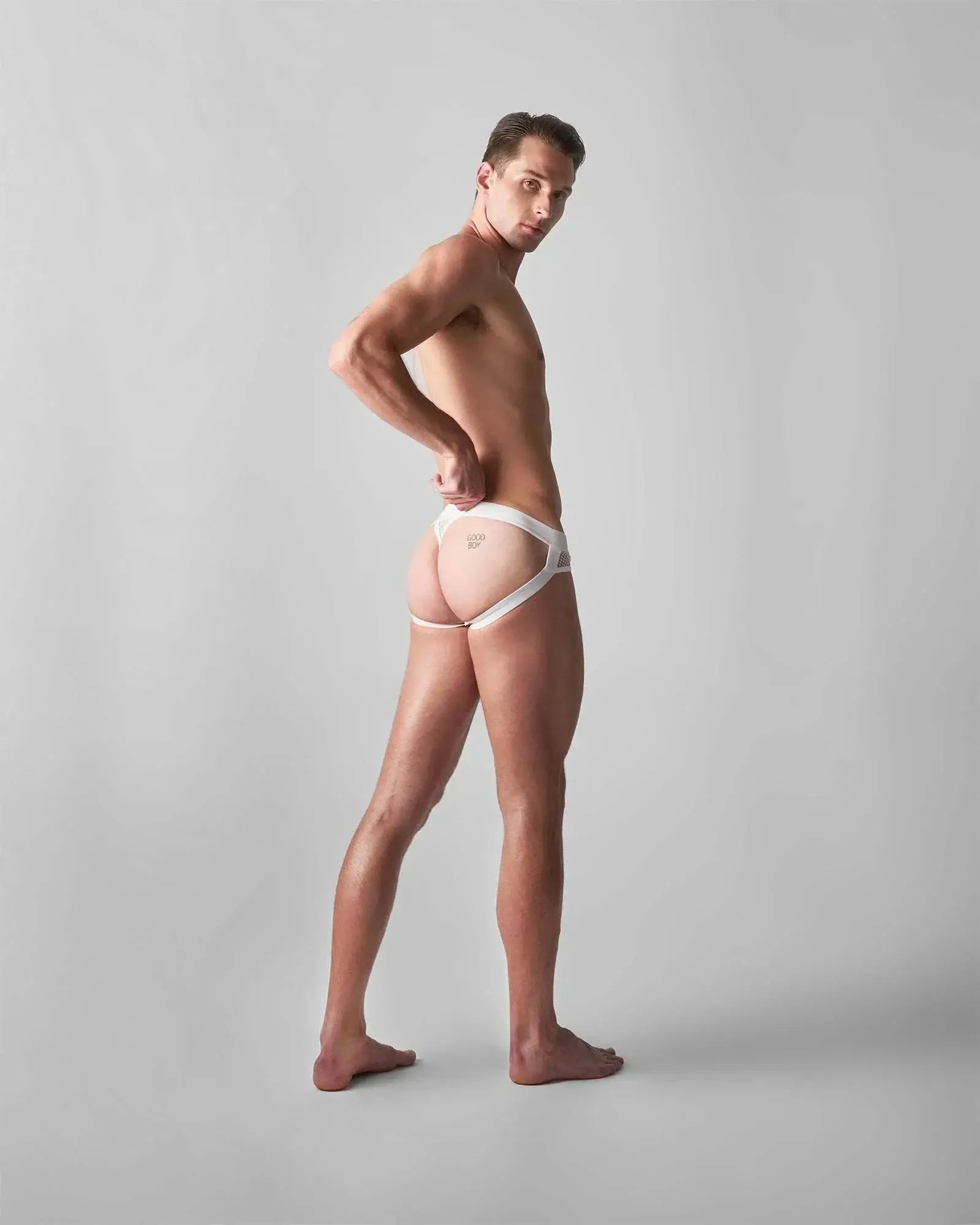 White lace-trimmed edge net jock thong with minimalist design and subtle front branding for comfortable wear