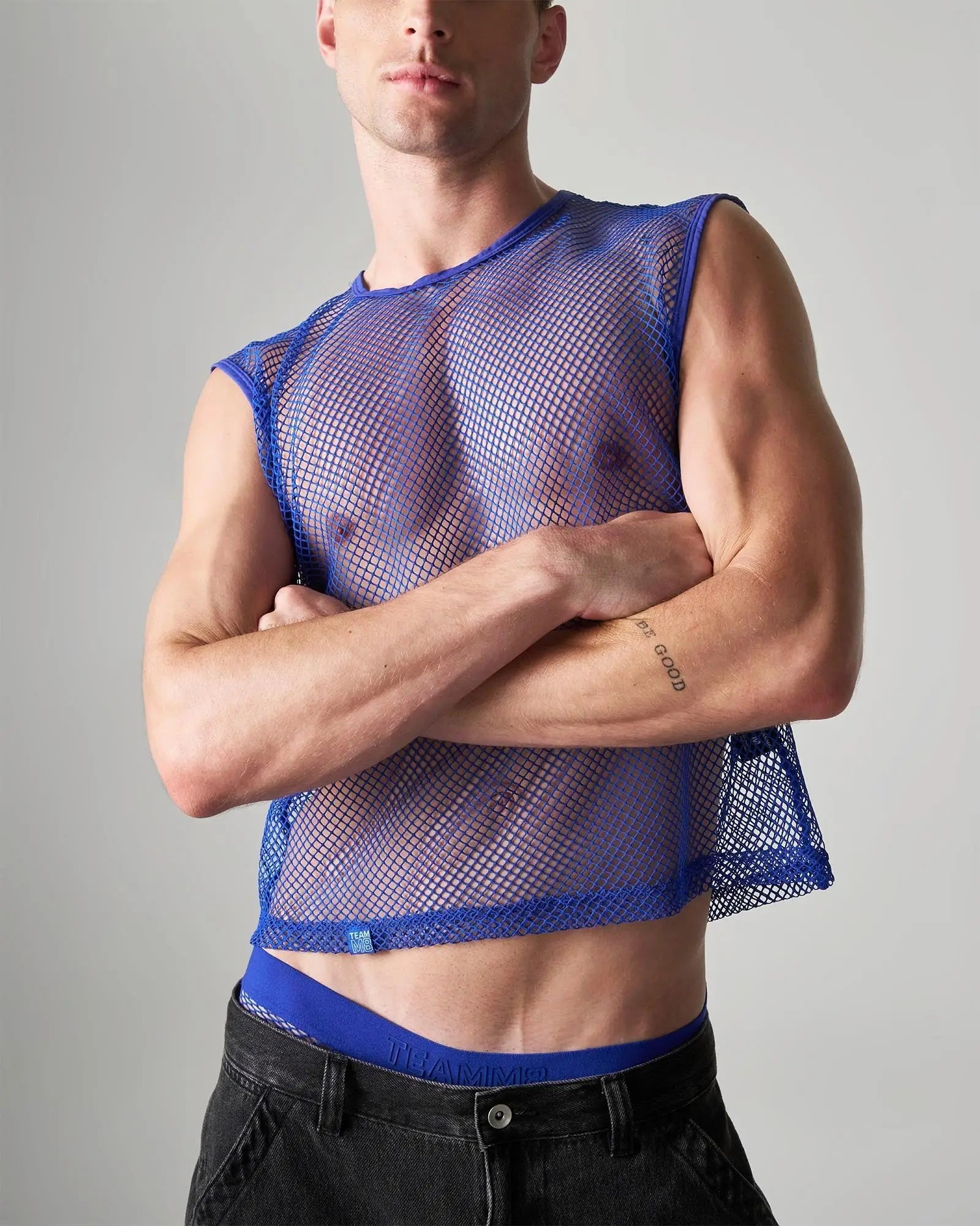 Blue mesh sleeveless muscle tank with a fitted cropped design made from breathable edge net material