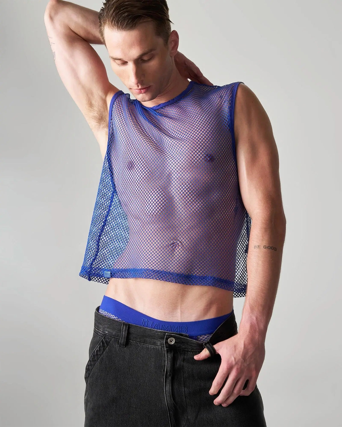Edge net mesh muscle tank blue sleeveless top with sheer translucent fabric and reinforced blue trim along neckline and hem