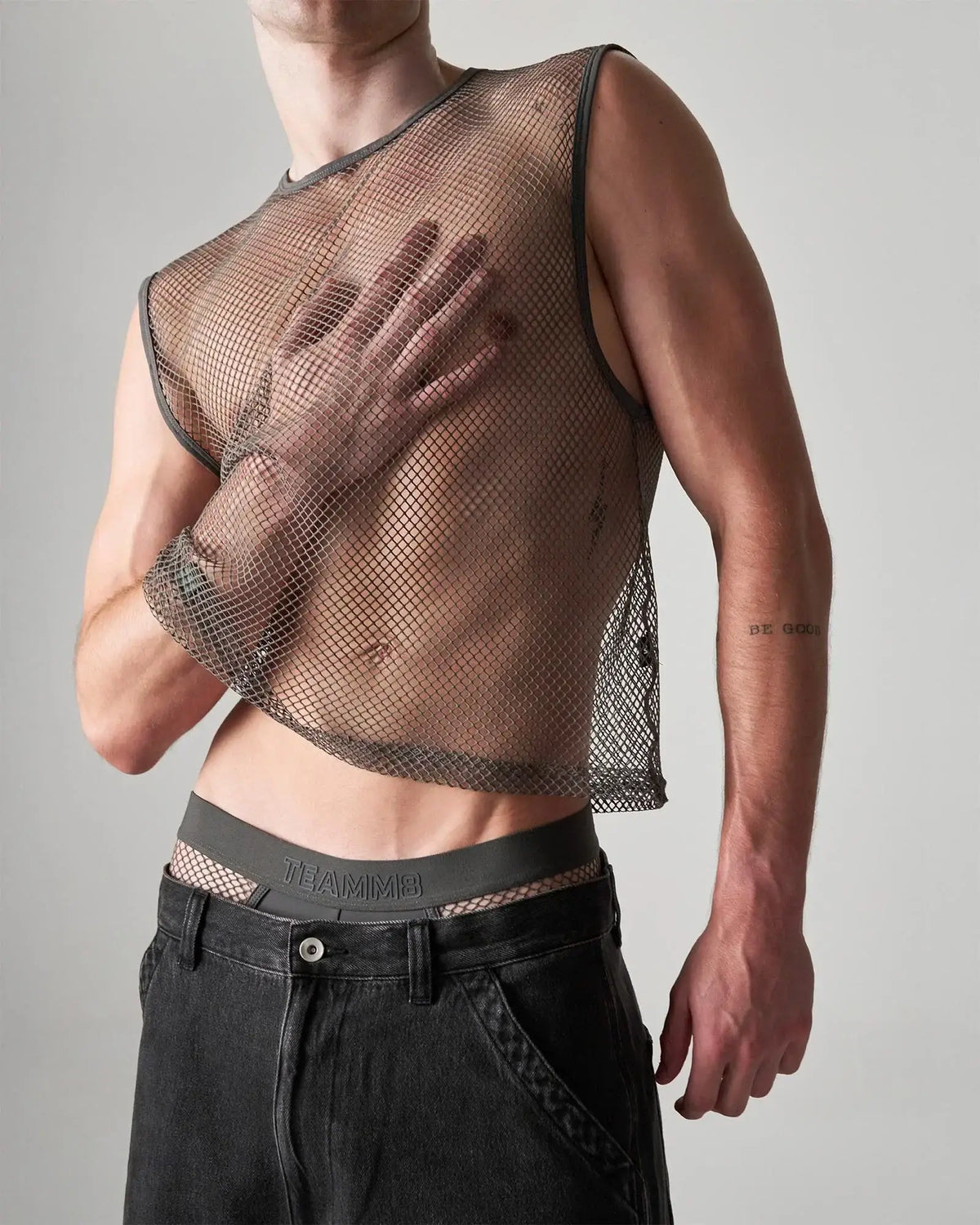 Dark gray edge net mesh muscle tank with fitted cropped design and reinforced shoulder seams
