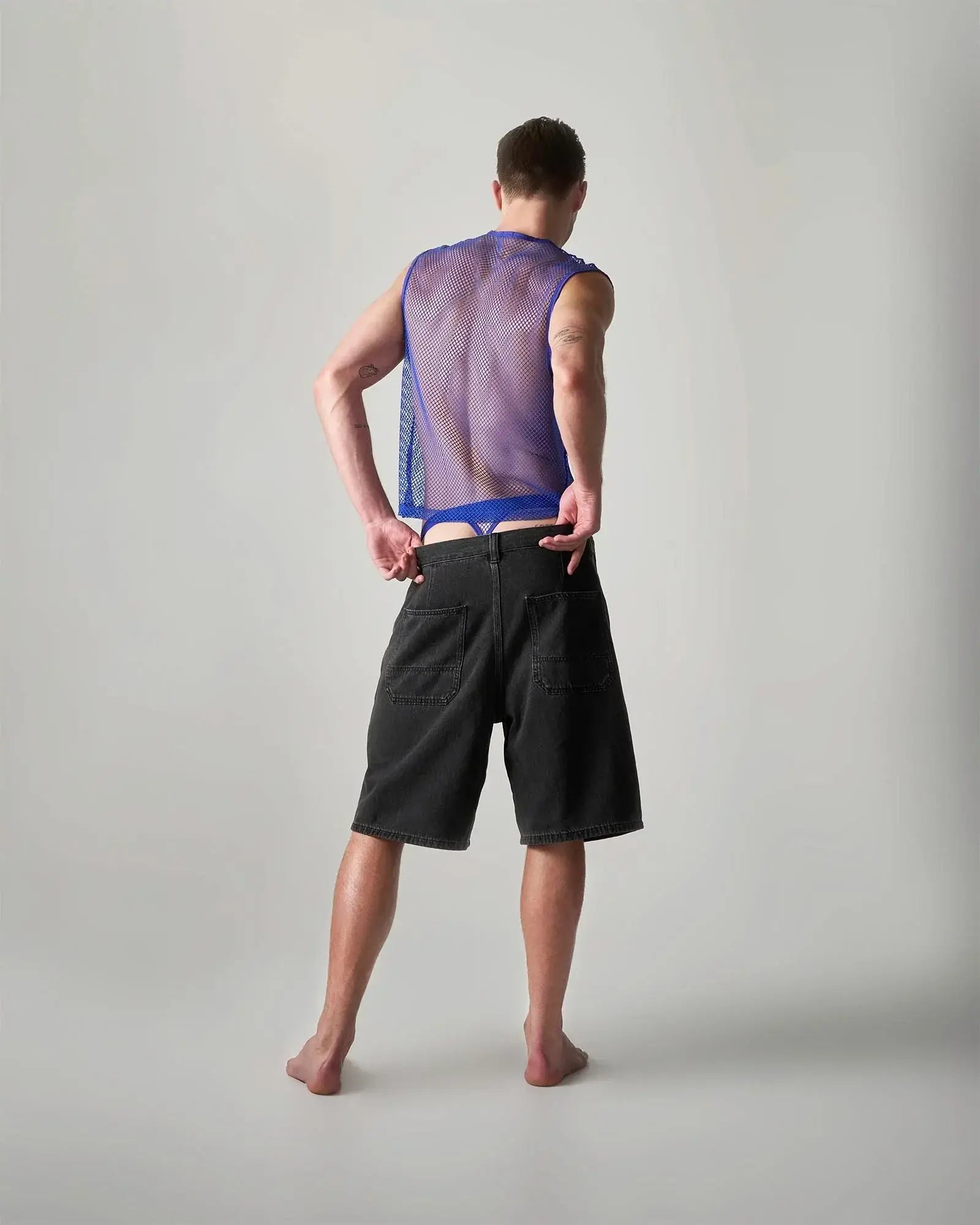 Edge net mesh muscle tank featuring a translucent purple mesh fabric with a blue waistband for breathable comfort