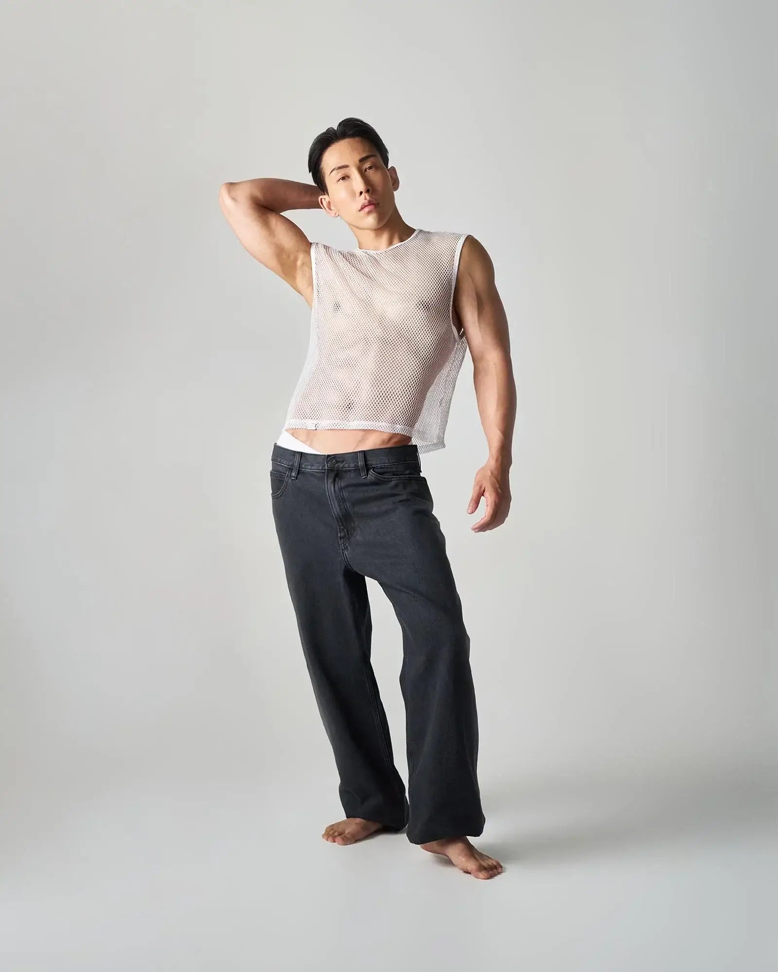 Edge net mesh muscle tank featuring a white fitted sleeveless top with a semi-transparent mesh design