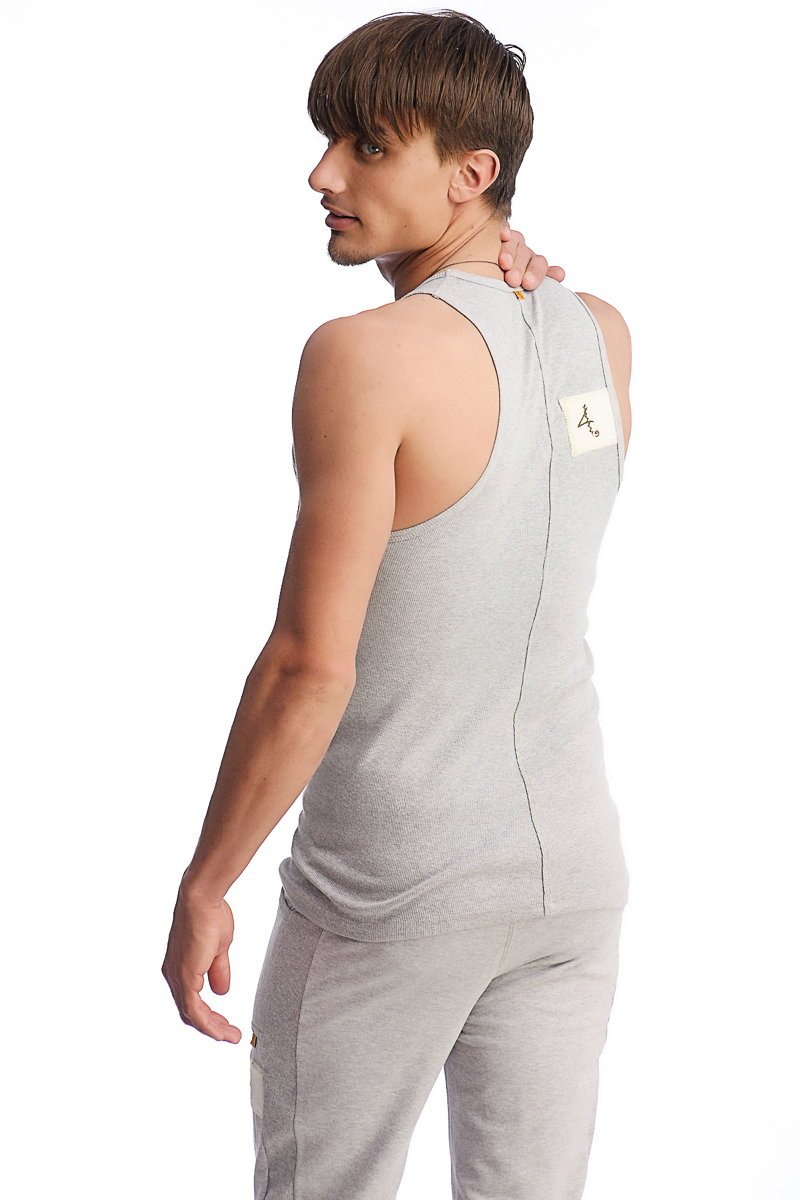 Back view of edge sustain tank top in heather grey with subtle vertical seam and small white label near shoulder