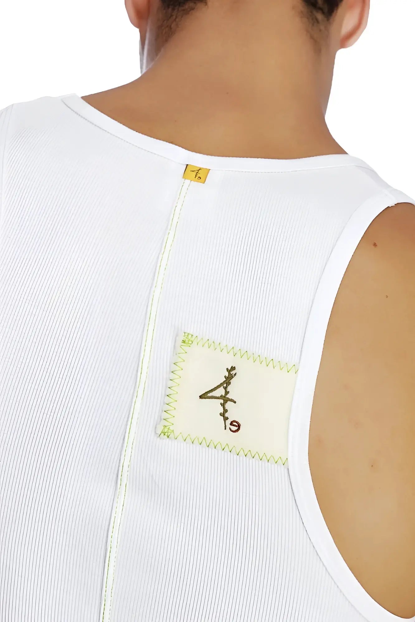 White ribbed sleeveless edge sustain tank top with cream patch and black embroidery accented by lime green stitching