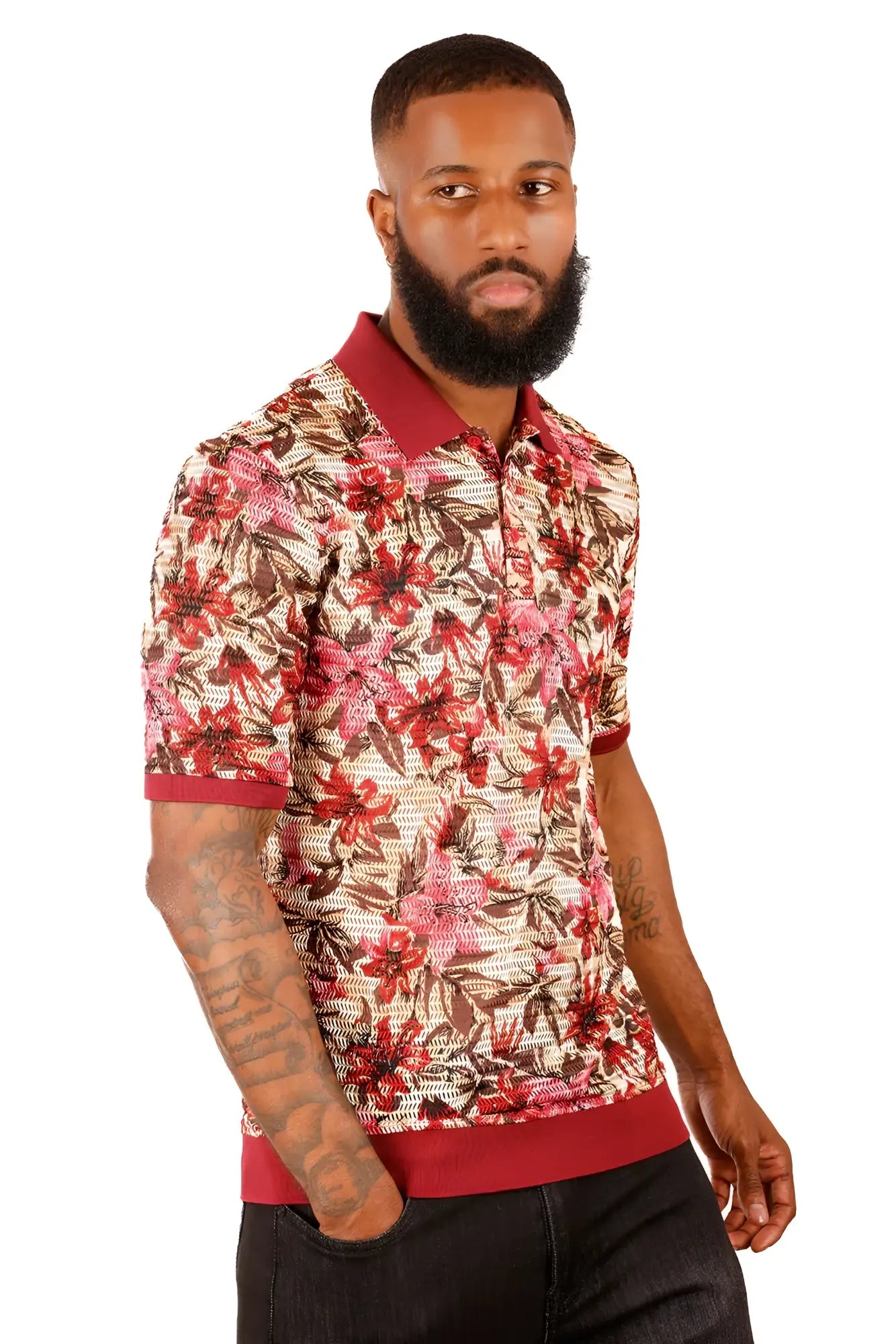 A man wearing an entwine form polo shirt with a red pink and brown floral pattern on beige with maroon trim