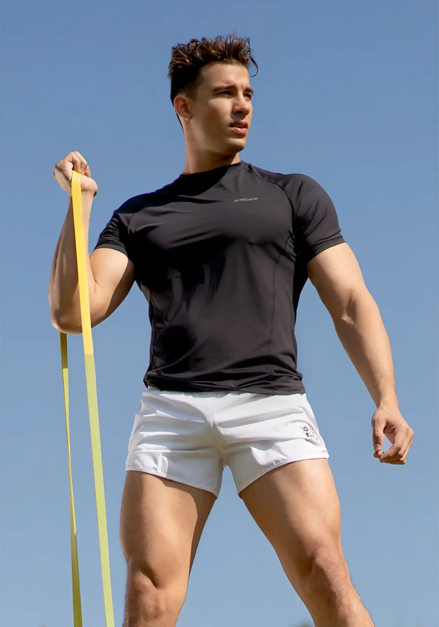 Black athletic t-shirt with short sleeves and subtle logo, paired with ergowear built in x4d bikini mesh gym shorts white size m