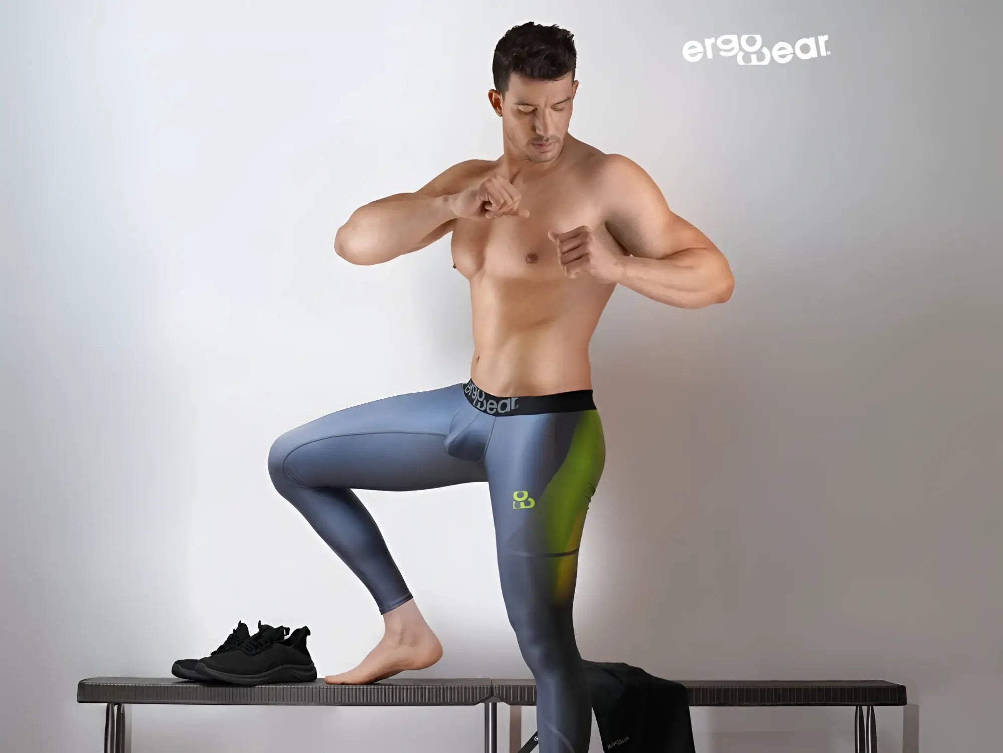 A pair of ergo wear ew1604 max se ergonomic men’s leggings in gradient blue and green with logo waistband