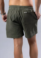 Olive green textured essential swim shorts with branded logo on back waistband available in 3 colors