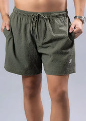 Olive green essential swim short with textured fabric drawstring waistband and embroidered logo on lower right leg
