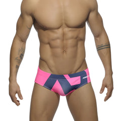 Extra-large logo brief men’s swim trunks in bright pink and navy blue geometric pattern with addict branding