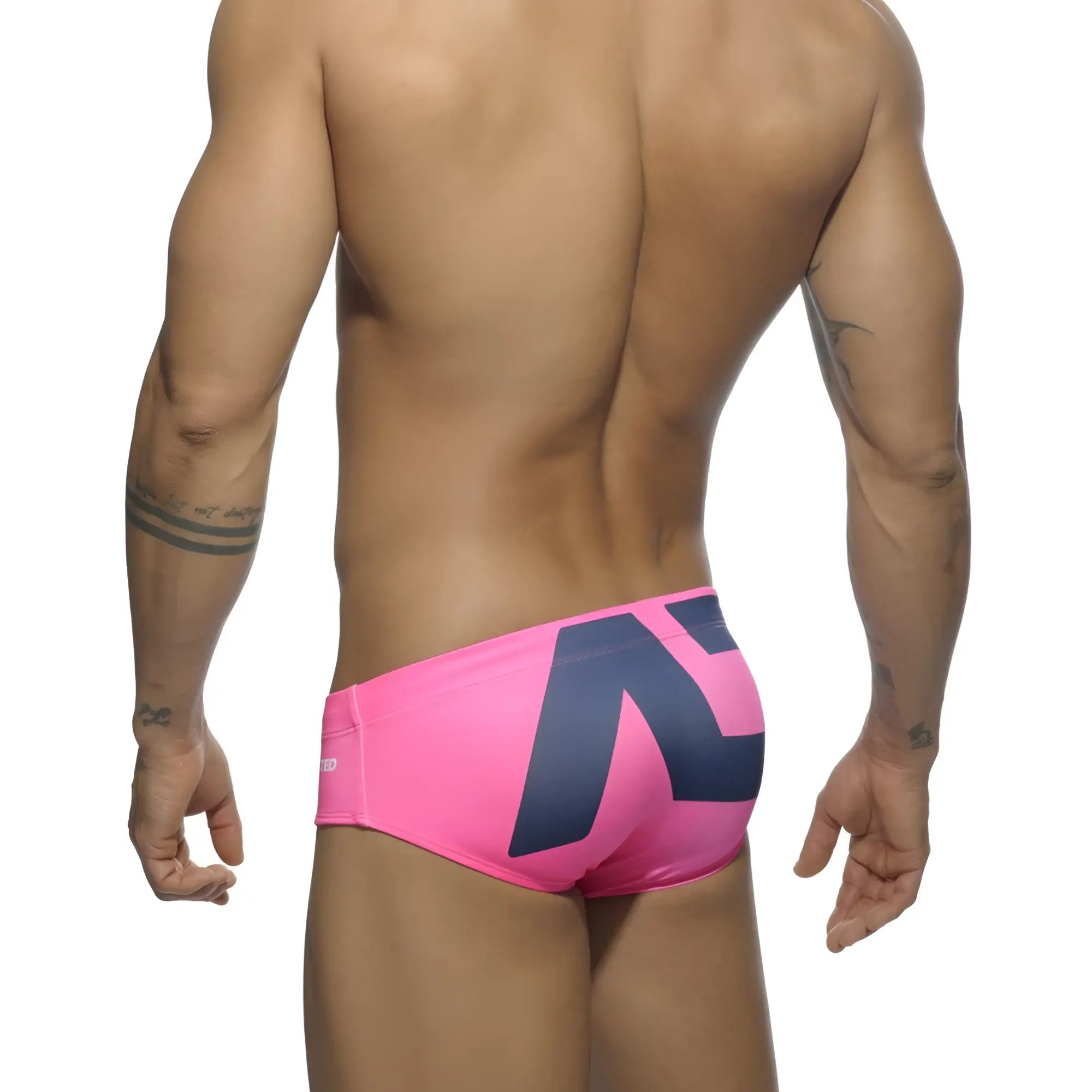 Bright pink extra-large logo brief swim trunks with a bold navy blue geometric logo on the back side