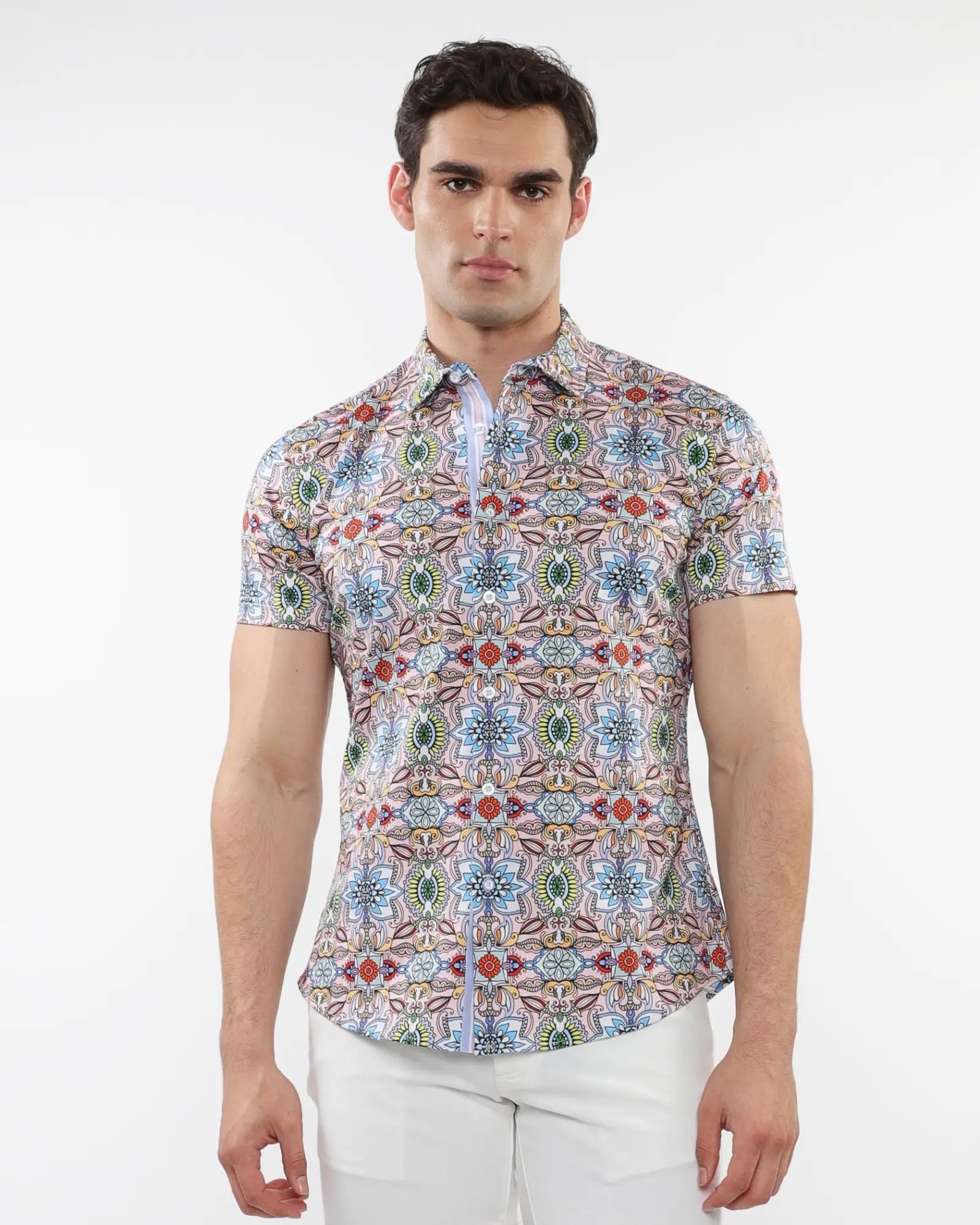 A man wearing a fauna print stretch knit short-sleeved shirt with colorful geometric patterns in blue green red and beige