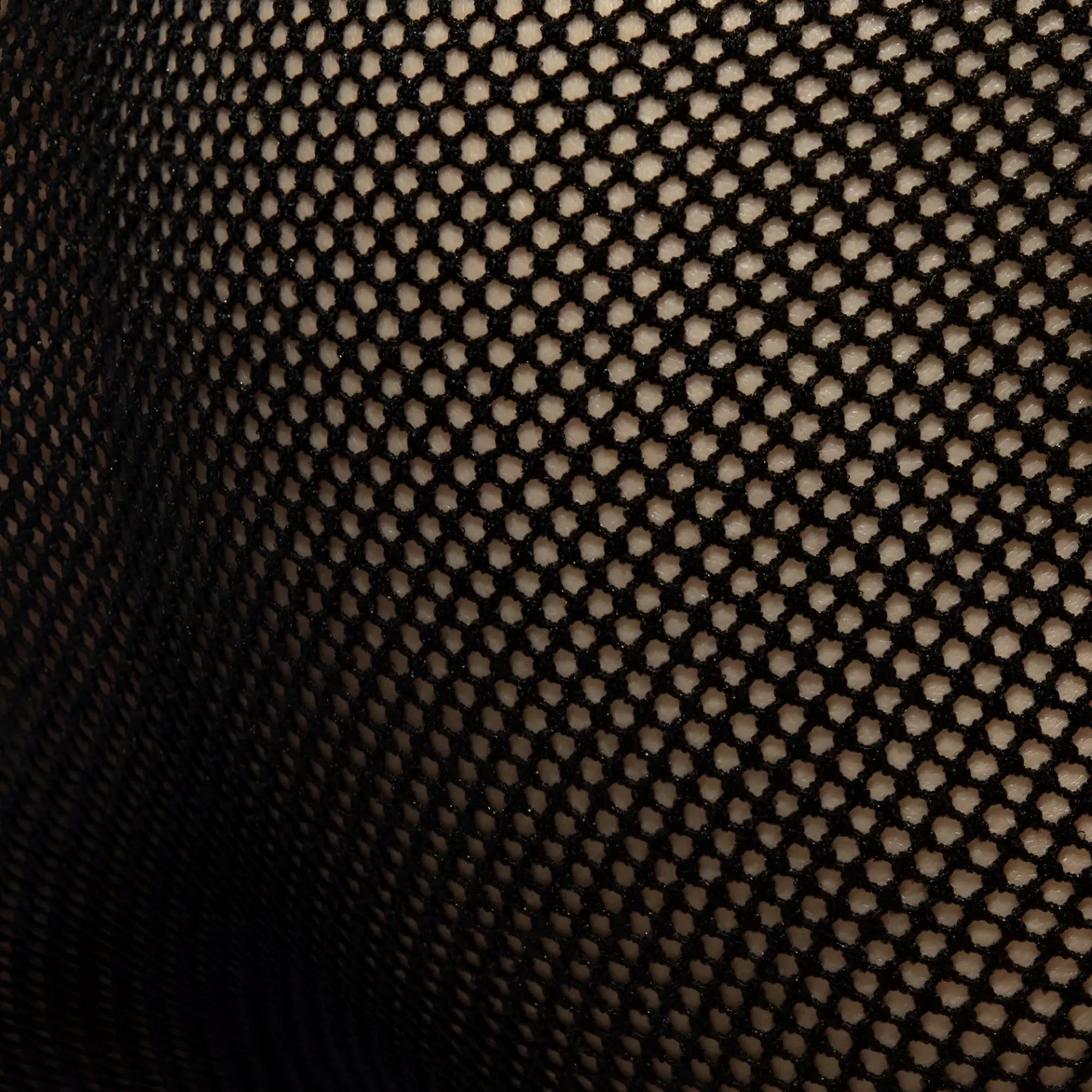 Black fever mesh brief fabric showing a consistent hexagonal mesh pattern in breathable black material