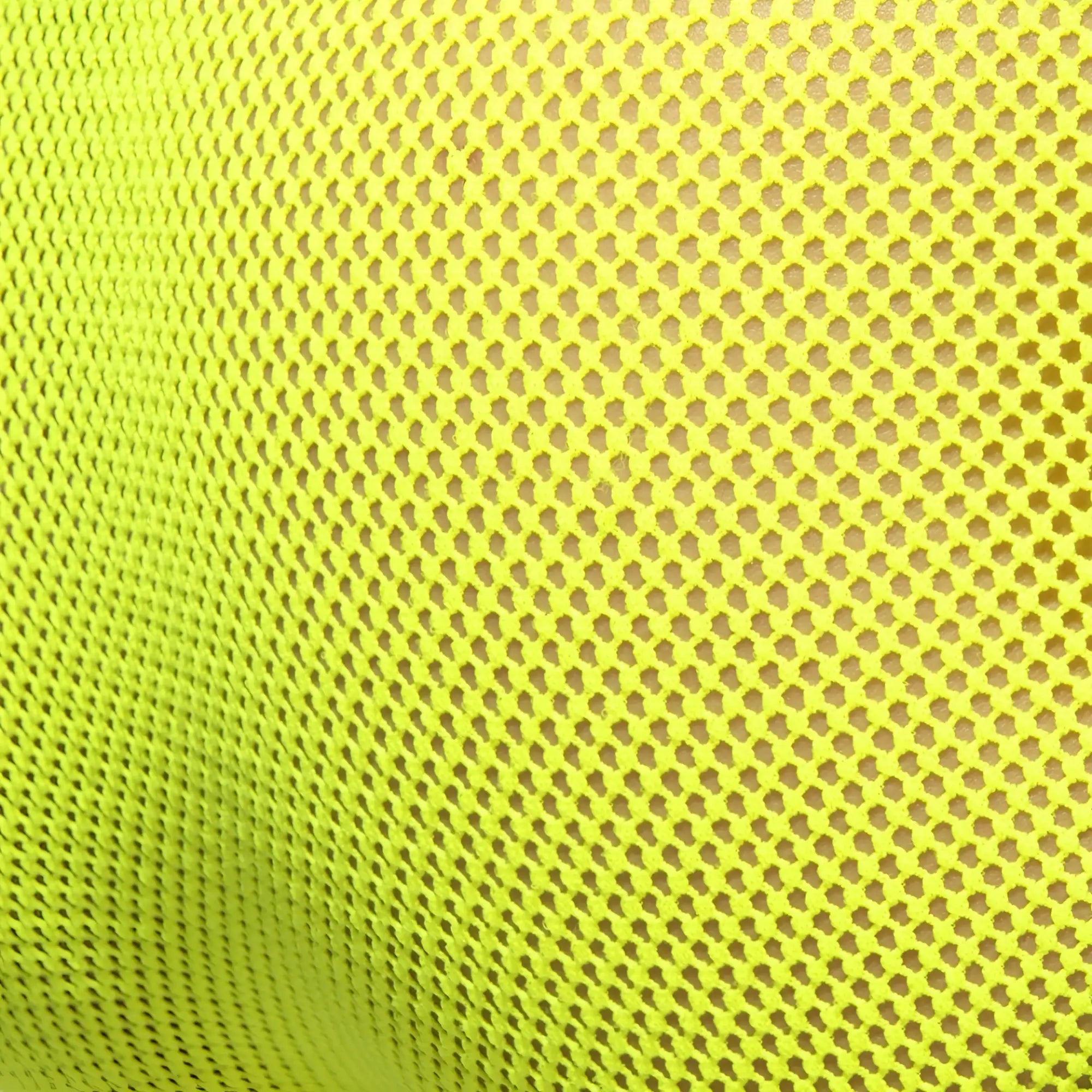 Fever mesh brief made of bright neon yellow breathable mesh fabric with a consistent hexagonal pattern