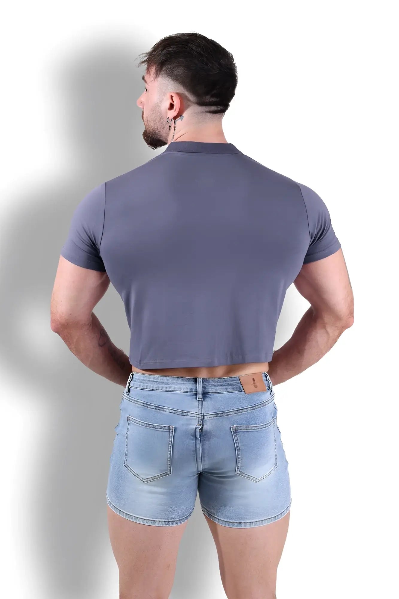 A fitted polo crop top in dark grey made from stretchy fabric with short sleeves for a sleek look