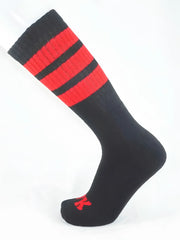 Fk sport black tube sock featuring bold red stripes and a small red logo on the toe in athletic fabric