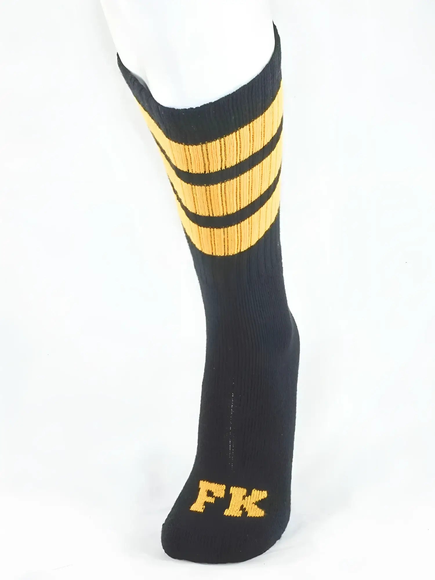 Fk sport black tube sock with three gold stripes near the top and fk embroidered in gold on the toe