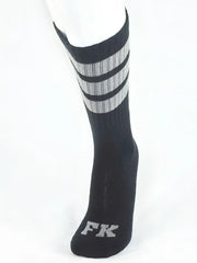 Black athletic tube sock with three gray stripes near top and silver fk logo embroidered on the toe for sports use