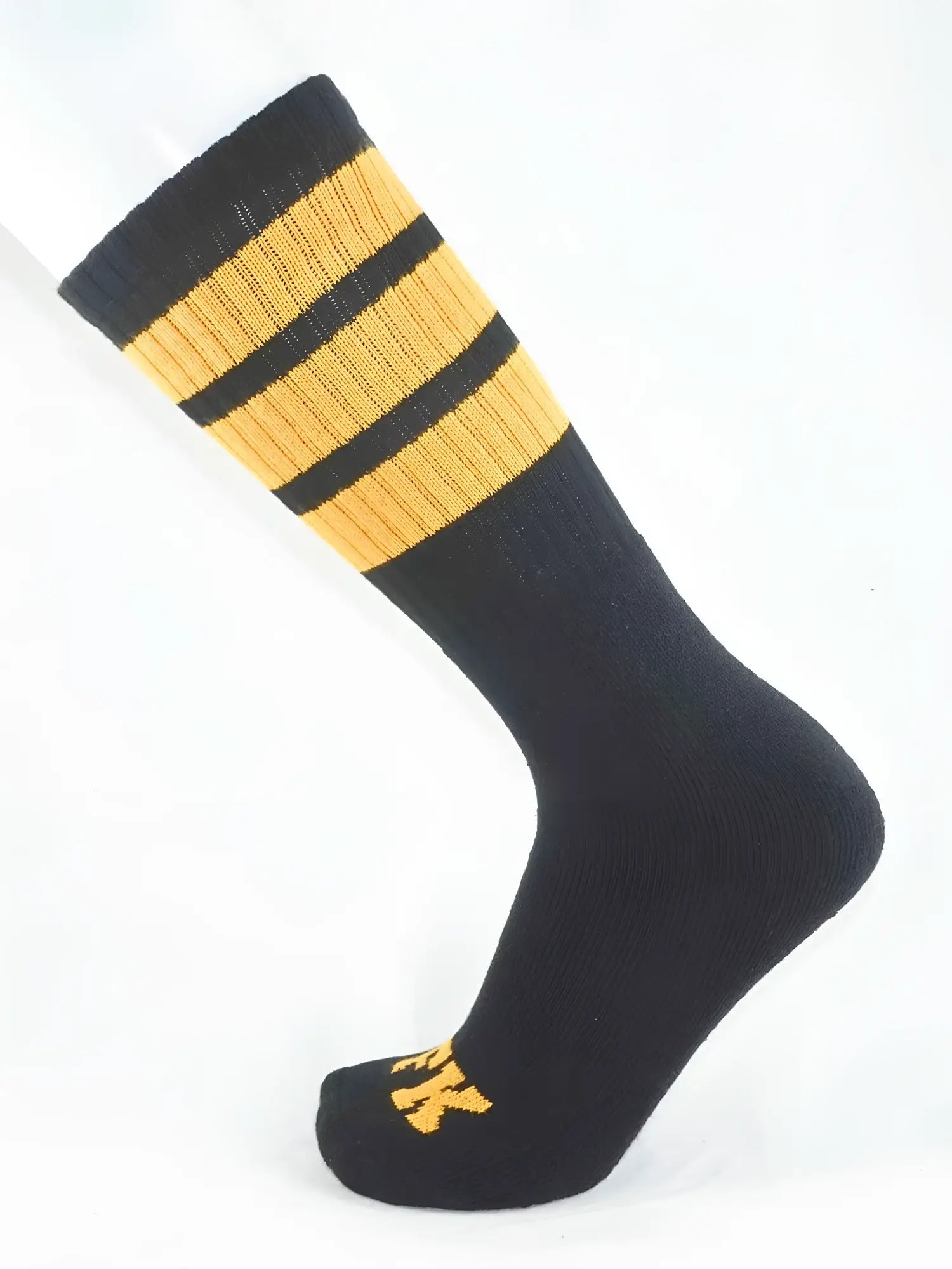 Fk sport black tube sock with three gold stripes near the top and a small gold logo on the toe for athletic use