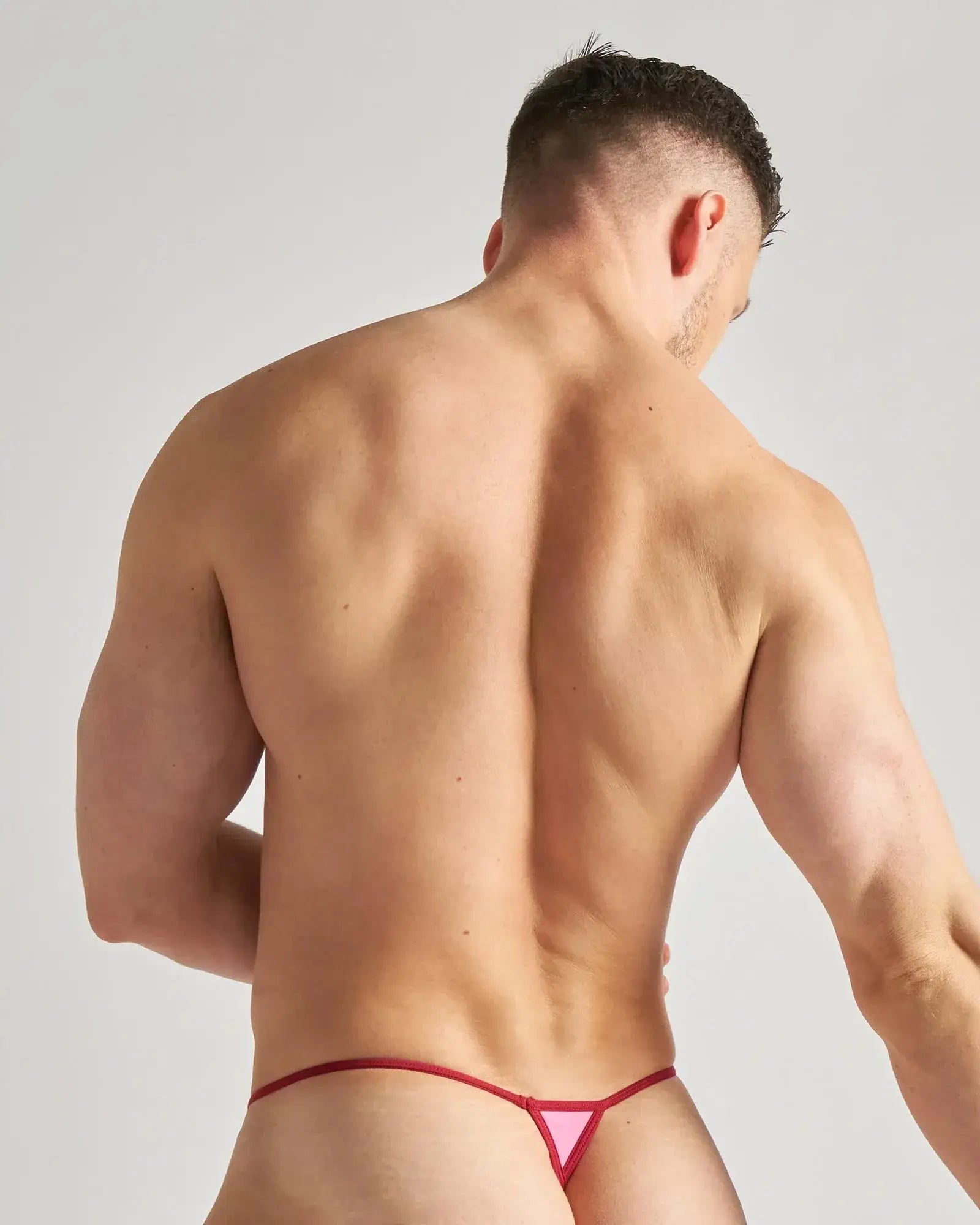 Pink flaunt micro thong with red trim features a triangular thong design made for bold and minimal coverage