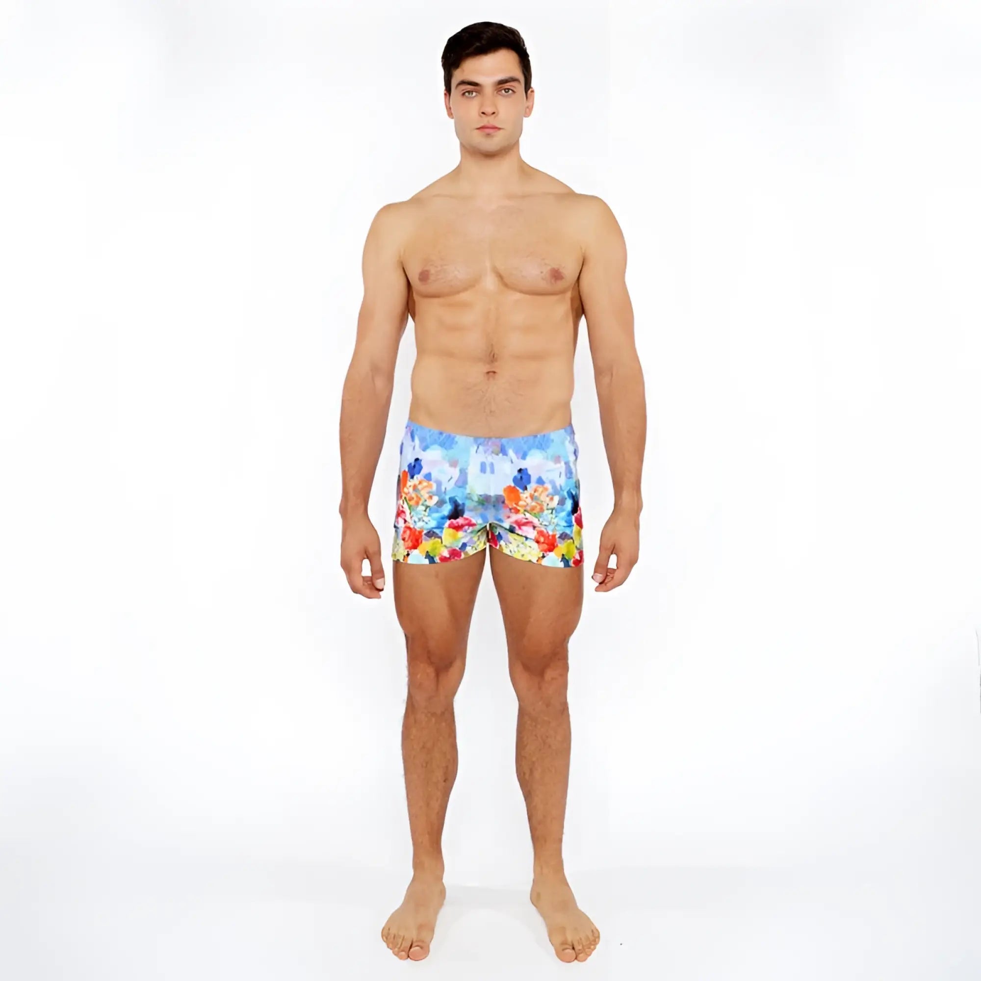 Men’s floral abstract printed swim shorts with vibrant red yellow and blue flowers on a light background