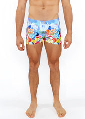 Vibrant multicolored floral abstract printed swim shorts with lively castle print in blue red yellow and orange