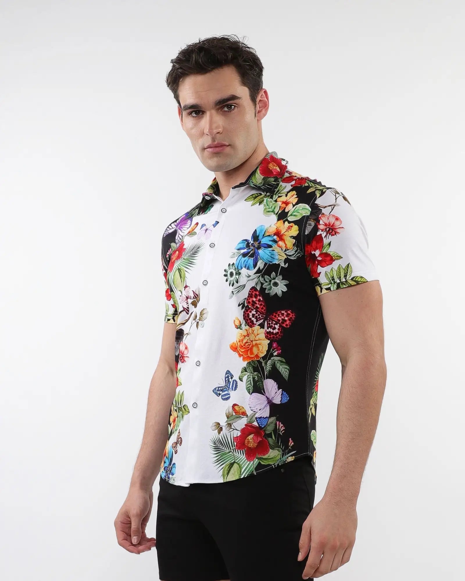 Floral border print stretch knit shirt with vibrant tropical floral and butterfly design on white and black background