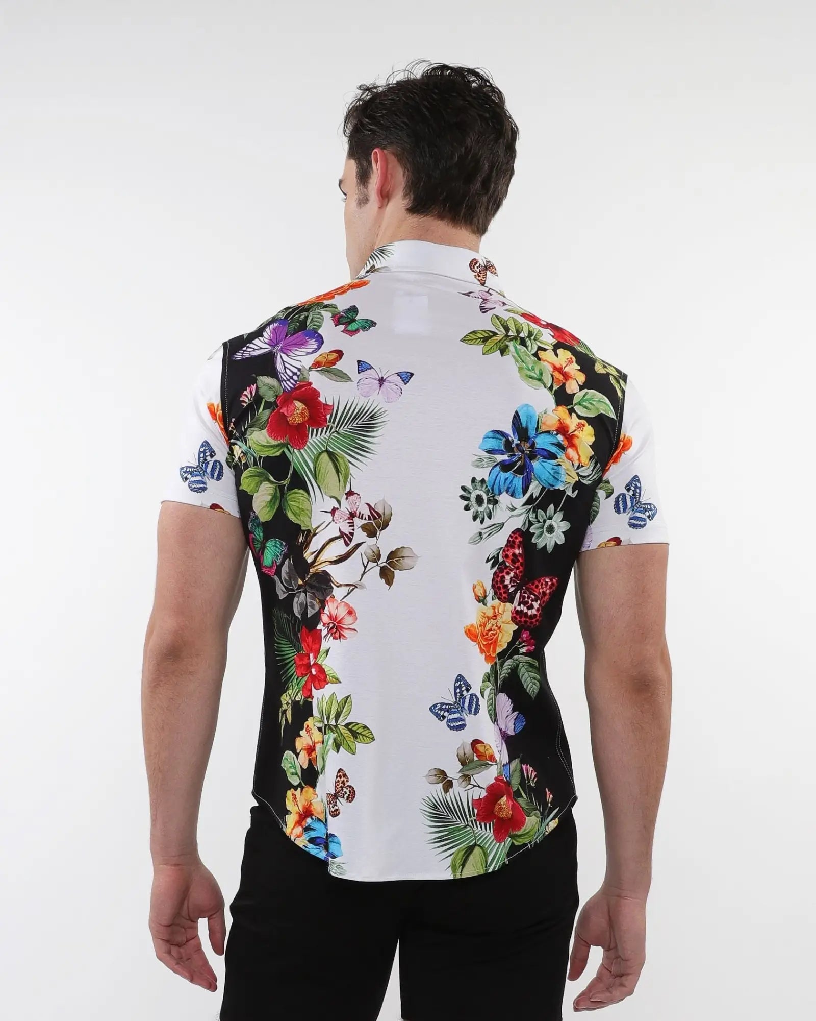 Floral border print stretch knit shirt with vibrant red blue purple and green floral and butterfly design on white base