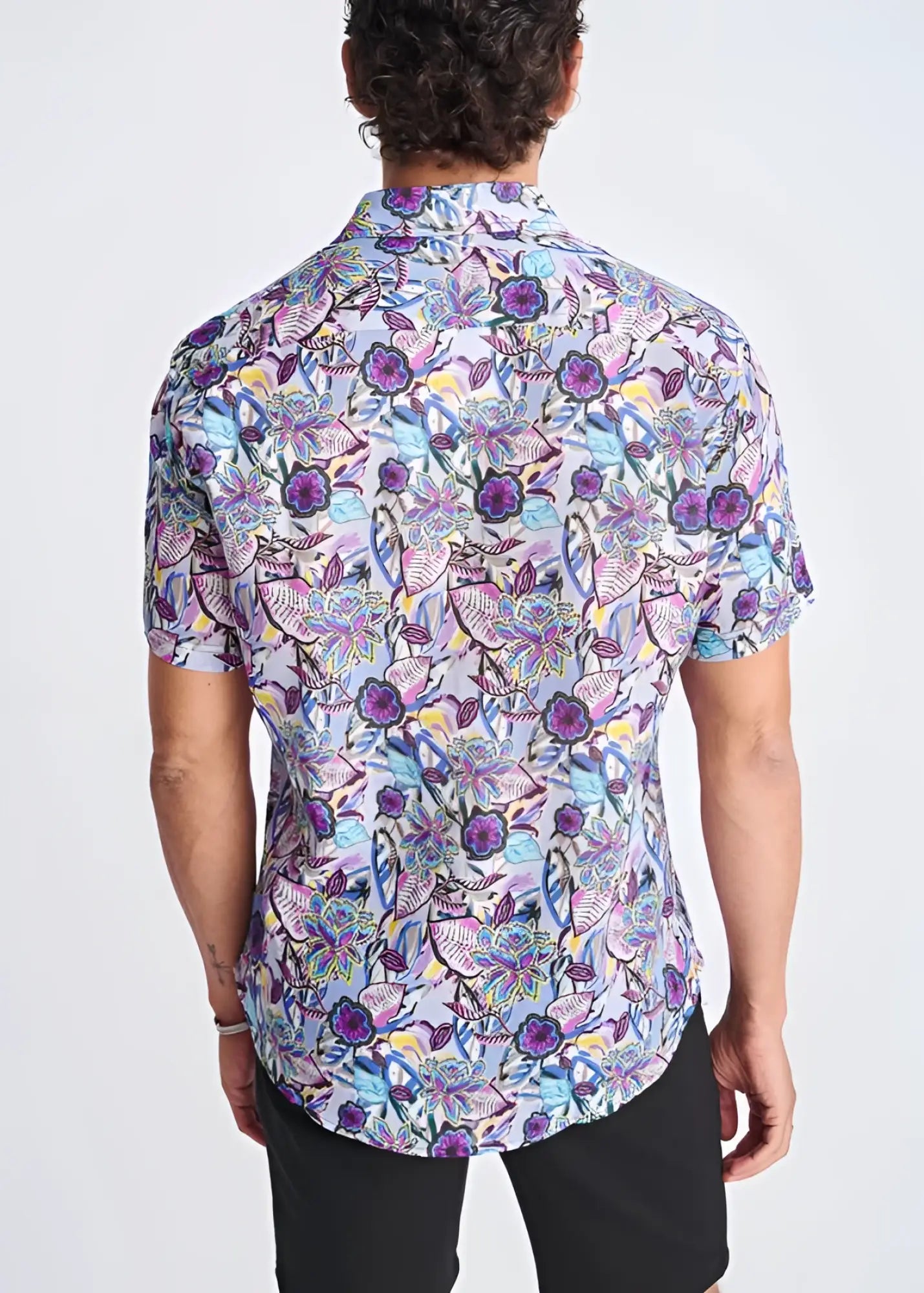 A vibrant floral lightweight linen tencel short-sleeved button-up shirt in purple blue and pink on light background