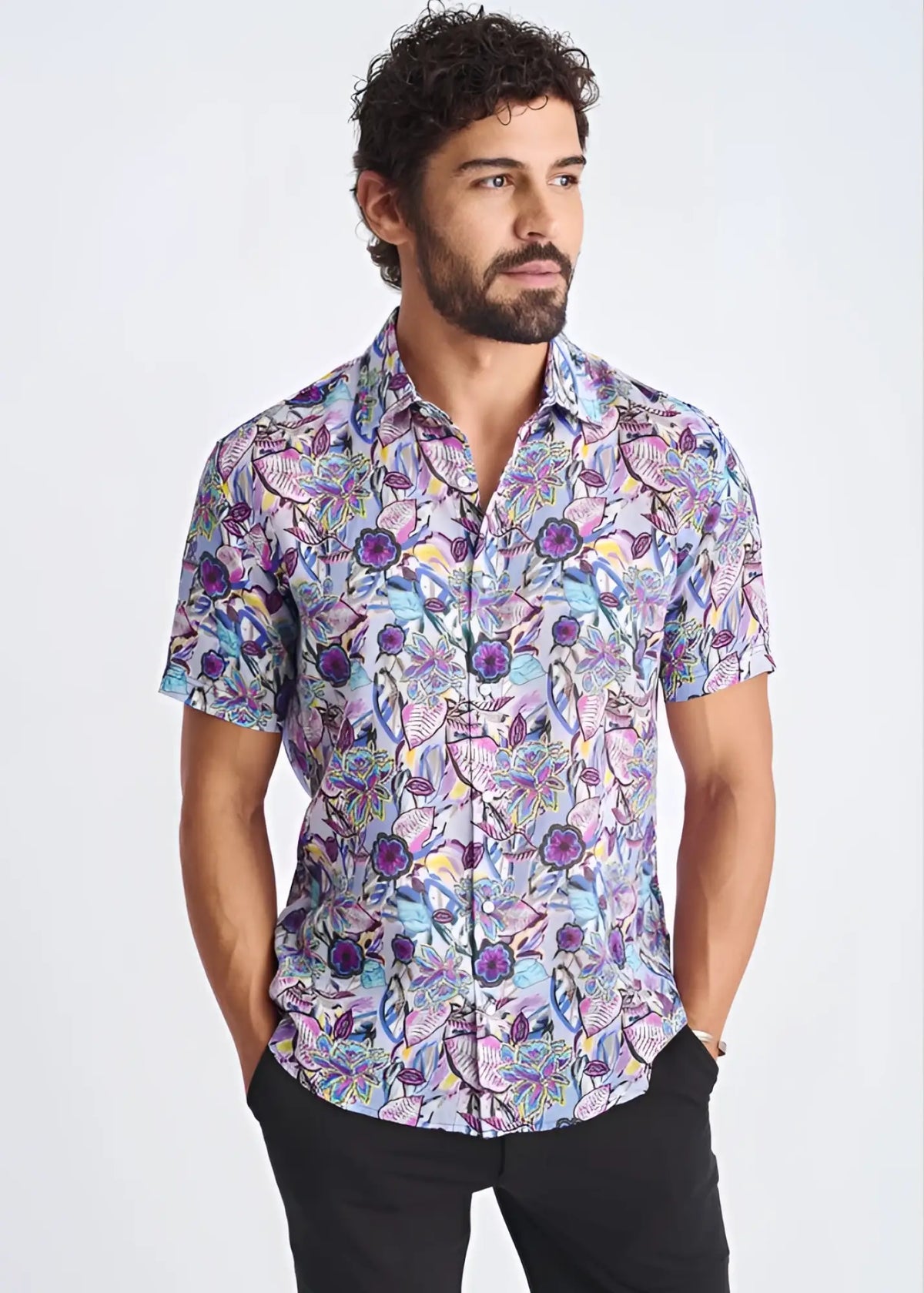 A lightweight linen tencel short-sleeved shirt with a purple blue and pink floral pattern on light lavender background