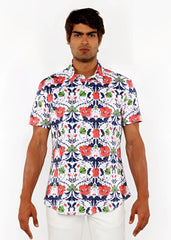 A man wearing a floral print stretch knit shirt with red poppies green leaves and navy blue vines on a white background