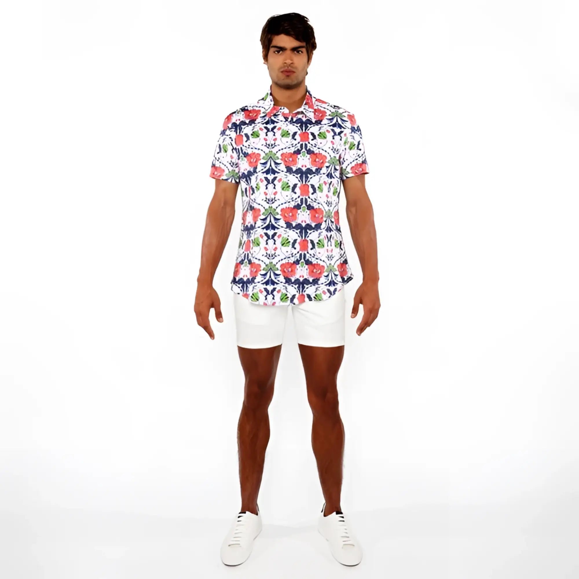 A man wearing a floral print stretch knit short-sleeved button-up shirt in red blue and green on white background