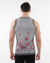 A man wearing a black and white polka dot floral printed mesh tank with stripe ribbing and pink roses along the bottom