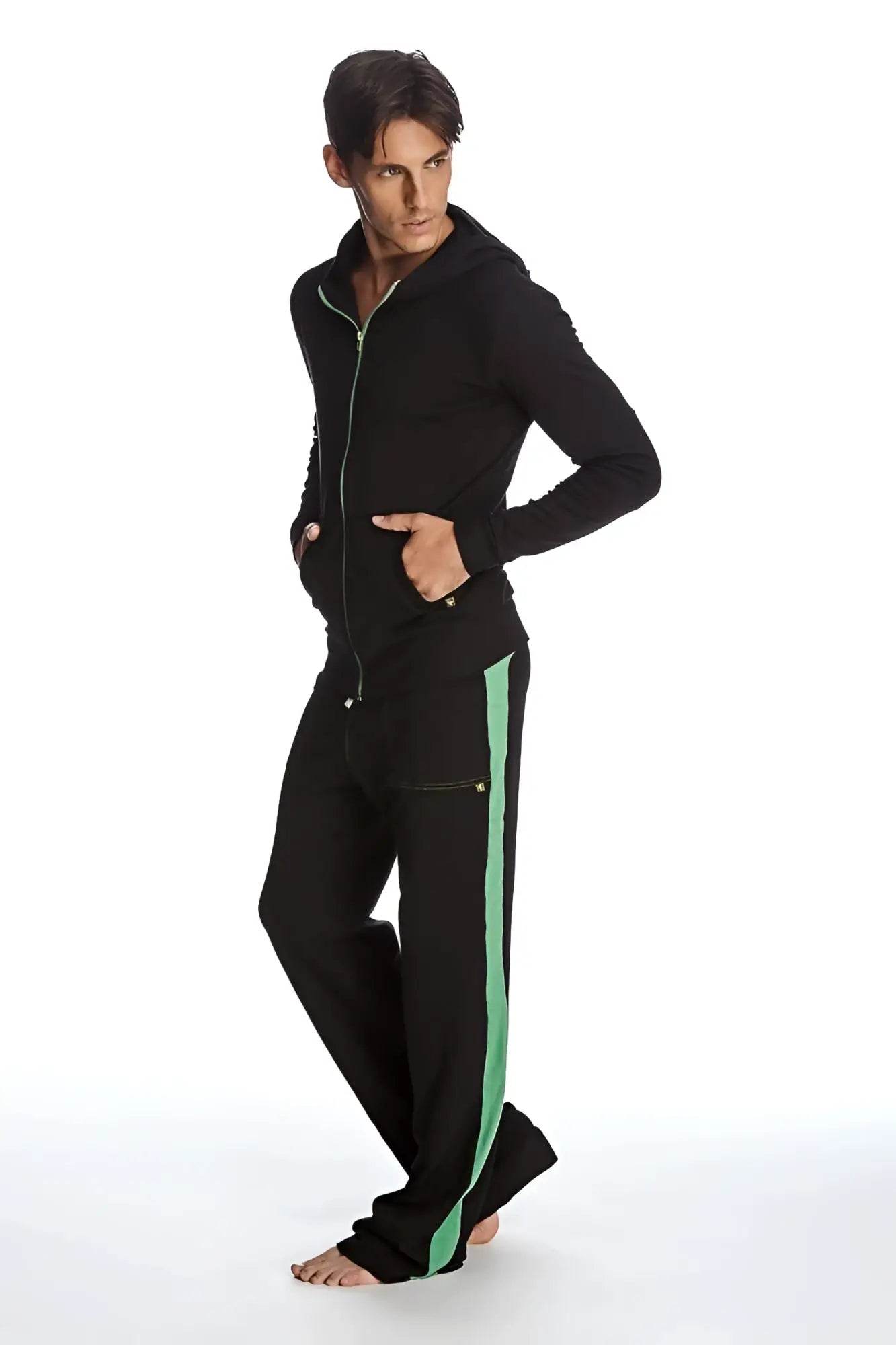 Form-fit crossover yoga track performance hoodie and pants set in black with vibrant green vertical side stripes