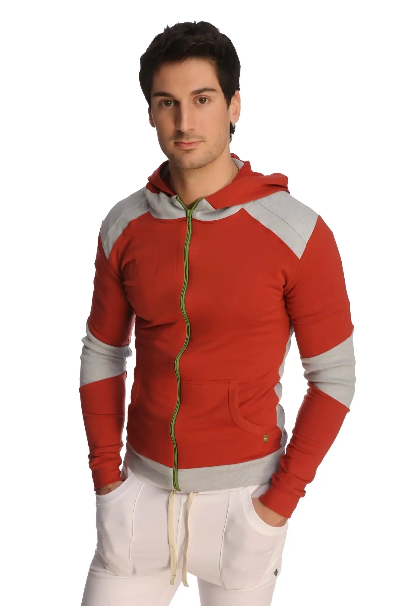 Form-fit crossover yoga track performance hoodie in cinnabar grey with red and gray panels, green zipper pull, and pockets