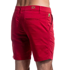 Red chino shorts with gold ex logo on waistband and green frog emblem on back pocket shown from back side